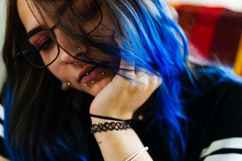 girl with blue hair and many lip piercings