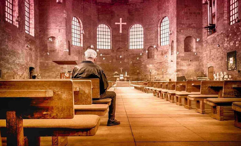 Man sitting in an empty church - A Witch Meets a Pastor: Learning From Spiritual Conversation