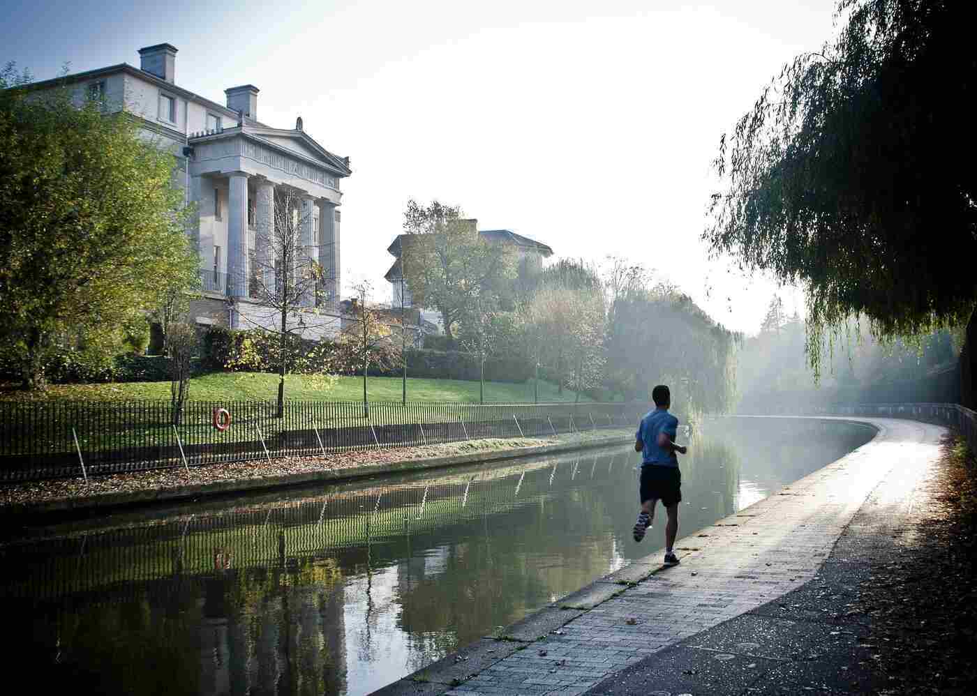 MINDFULNESS WHILE RUNNING: Make a mind-body connection and get in the zone 13 Man running on a pavement next to a water channel