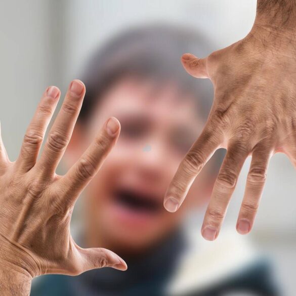 Upset child with adult hands pushing the emotion away - Mindful Journaling Techniques for Emotional Repression