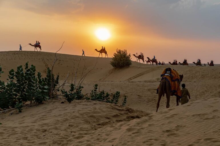 Camel ride across sand in Jaisalmer area of Thar Desert