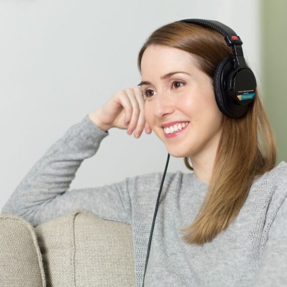 Happy woman listening to headphones - Heal From Trauma: 5 Tips to Help You Start Your Healing Journey