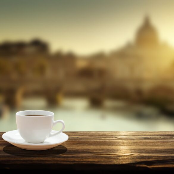 Cup of coffee on railing with St. Peter's Basilica in background - No Church Is Needed to Connect With the Infinite Living Spirit
