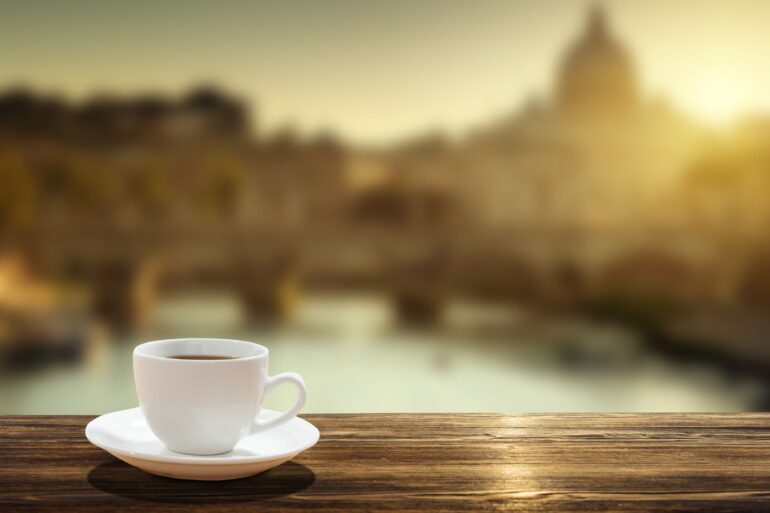 Cup of coffee on railing with St. Peter's Basilica in background - No Church Is Needed to Connect With the Infinite Living Spirit