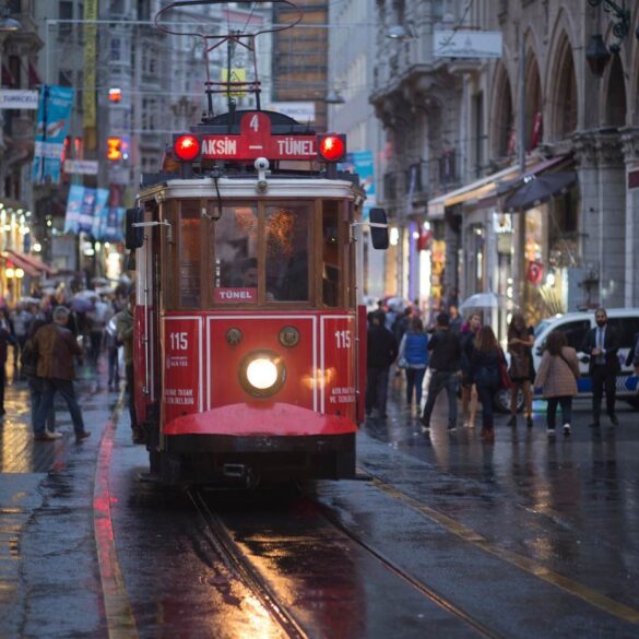 Train going down city street that's crowded with people walking - 3 Poems, Including "My Scattered Tribe"