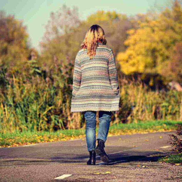 woman walking next to a river