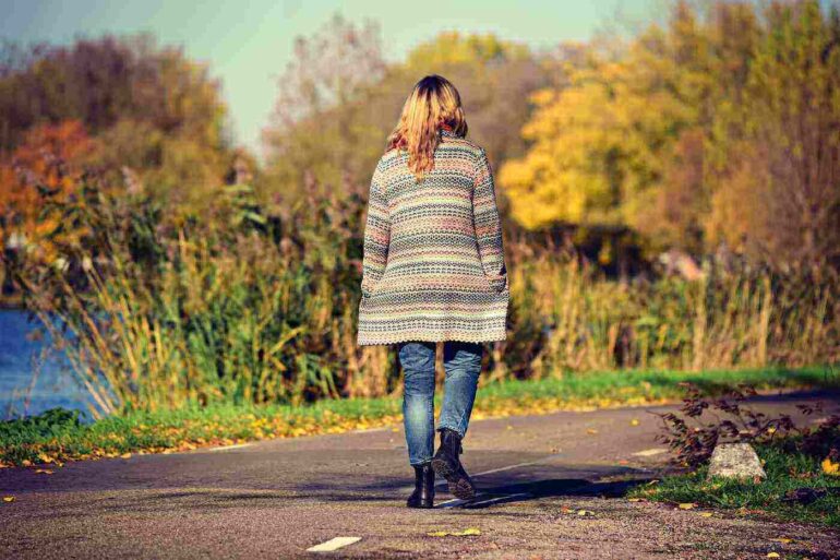 woman walking next to a river