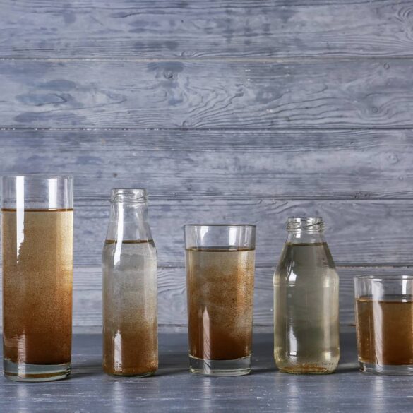 Five glass containers of water also filled with varying amounts of dirt - Practice Shamata by Observing a Candle for 3 Minutes a Day