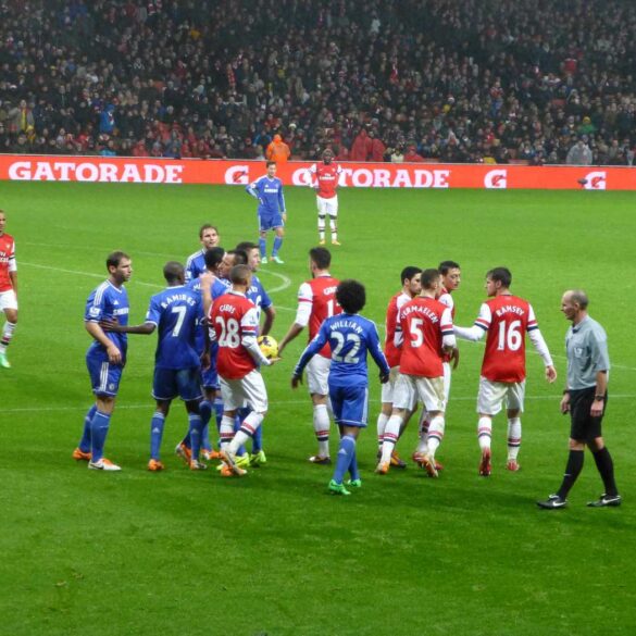 Chelsea vs. Arsenal British football game, with red and blue jerseys - Finding Freedom at a Charlie Cooke Football Game