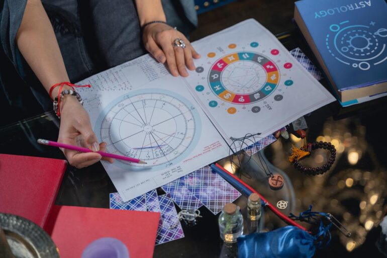 Female astrologer working with charts - 5 Misconceptions About Astrology and the Cosmic Connection