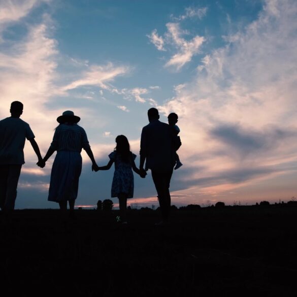 Silhouettes of family walking outside at sunset - 6 Mindfulness in Motion Tips for the Remote Worker