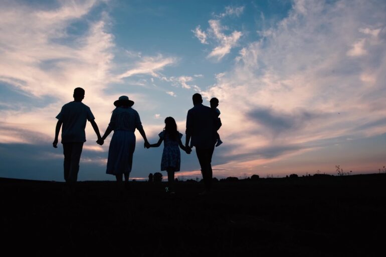 Silhouettes of family walking outside at sunset - 6 Mindfulness in Motion Tips for the Remote Worker