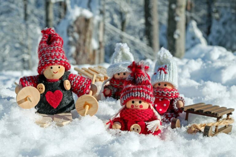 Family of Christmas doll figures outside in snow - Solo Strength: A Parent's Guide to Navigating the Holidays