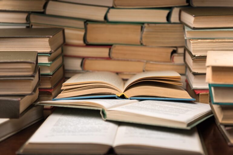 Stacks of old books - Stoicism Poems: How Do Modern Stoics Truly View Poetry?