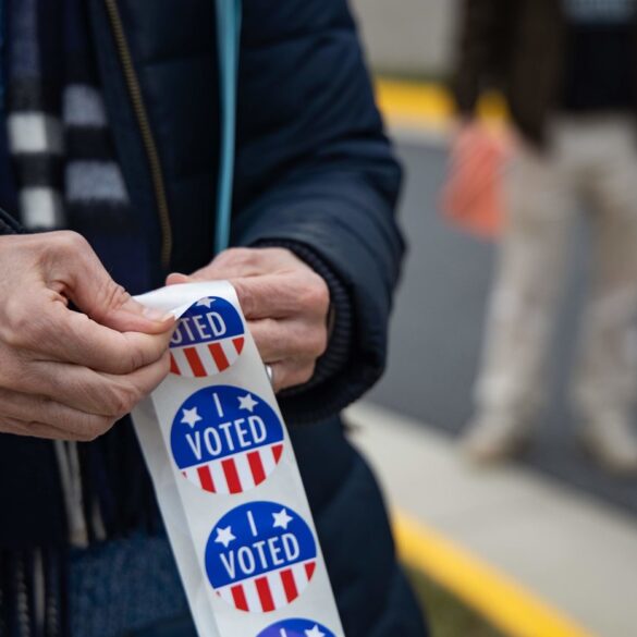 Person with "I VOTED" stickers at 2020 U.S. election polling station - A SENSE OF CARING: 4 responsibilities Americans must uphold