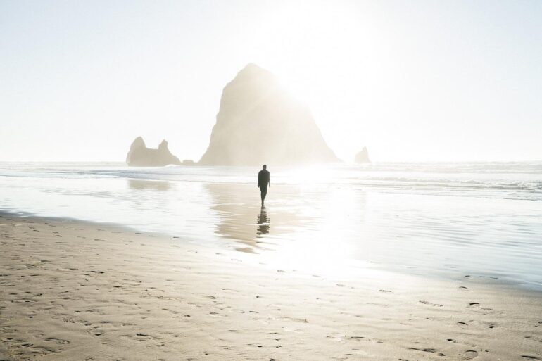Man alone on bright beach - Nihilism vs. Stoicism: Which Is the Better Life Philosophy?