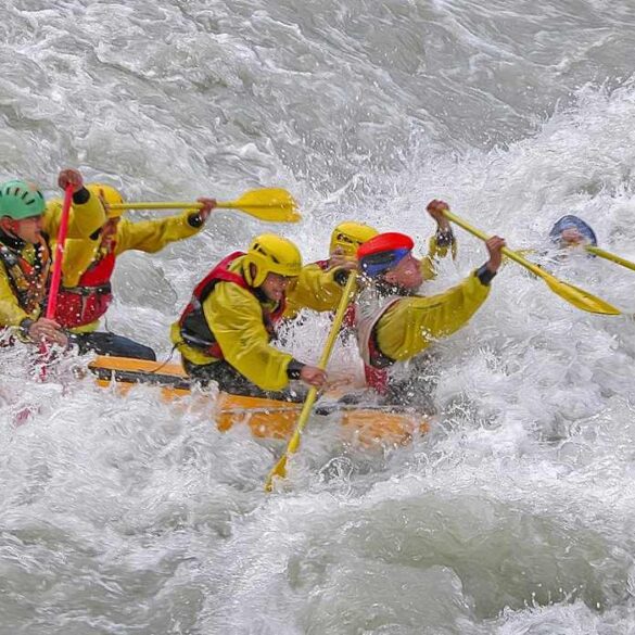 Five people paddling through rapids in raft - Stoicism for Inner Peace: Let the 4 Basic Virtues Guide You
