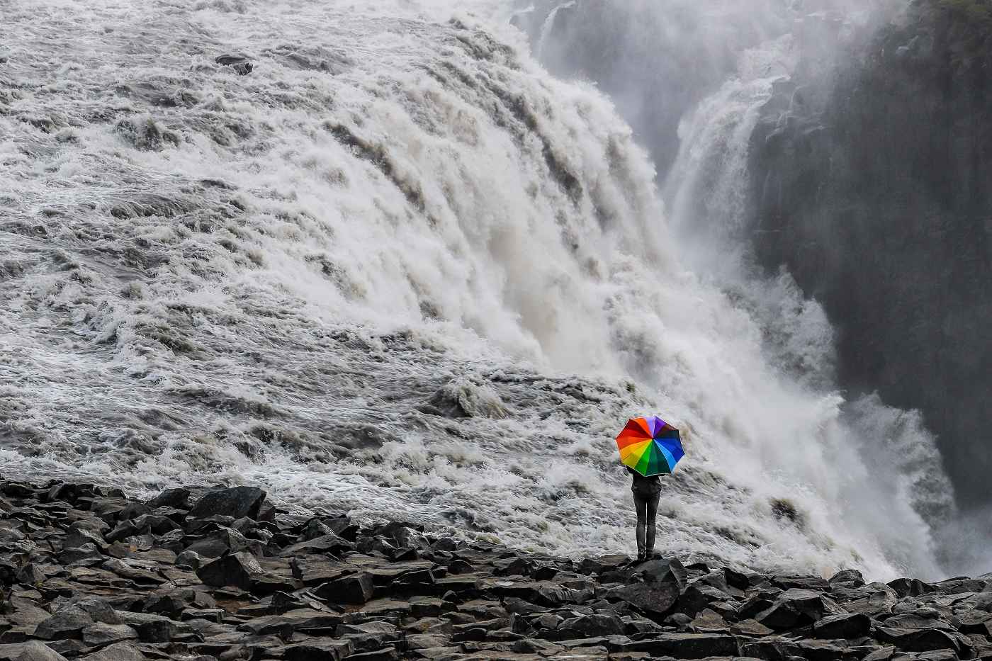 MINDFULNESS AND TRUTH: Some simple truths about being who we are 13 Person walking with rainbow-coloured umbrella near waterfall - Some Simple Truths About Mindfully Being Who We Are