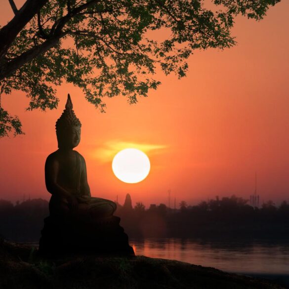 Statue of Buddha meditating at sunset - How Does Meditation Affect Our Relationship With Pain?