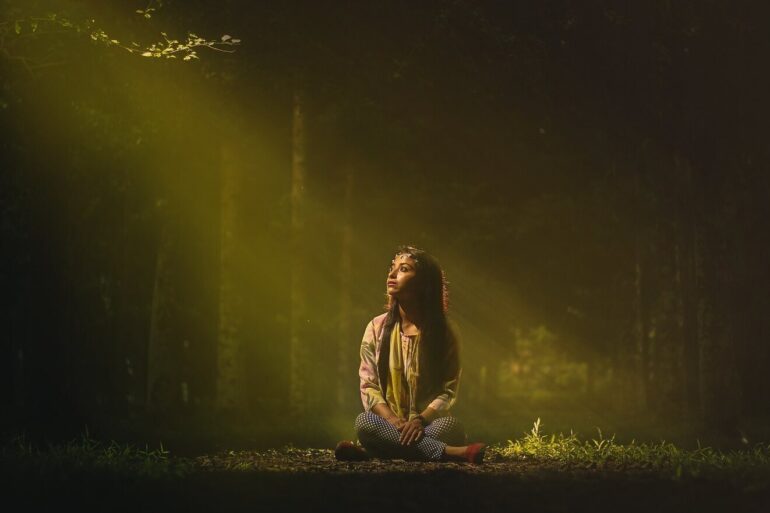Woman alone in a room sitting on the floor