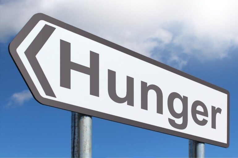 Road sign HUNGER - Food Waste: The Problem With Food Fights and Eating Contests