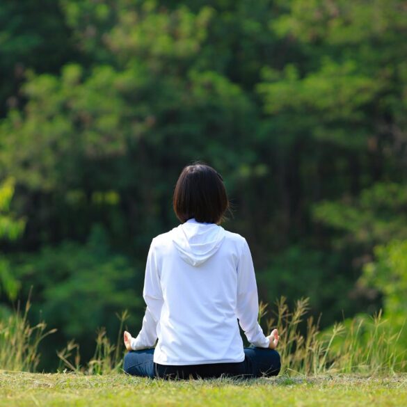Woman meditating outdoors
