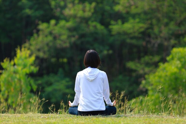 FOCUS ON PURE SENSATION: The second step in meditation teacher Barry Long's guide 17 Woman meditating outdoors