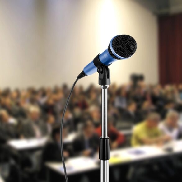Microphone in front of full lecture hall - Public Speaking: 4 Ways We Can Transform Our Silent Society