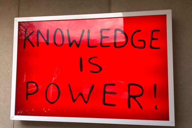 "Knowledge is power" on red background - Stronger Together: The U.S. Should Embrace Globalism in 2024