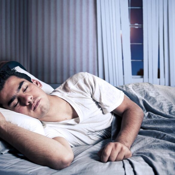 Young man sleeping in bed