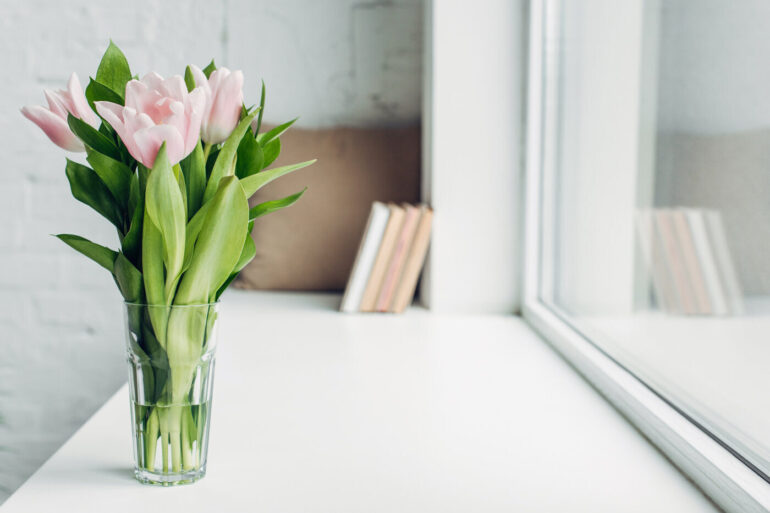 Natural flowers in vase on white windowsill - 13 Kondo-Like Living Tips to Give You Some Breathing Room
