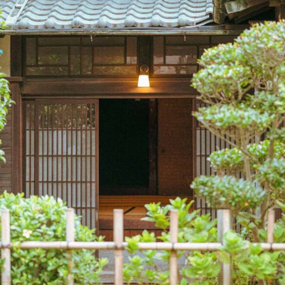 Wooden building with trees and gate in front