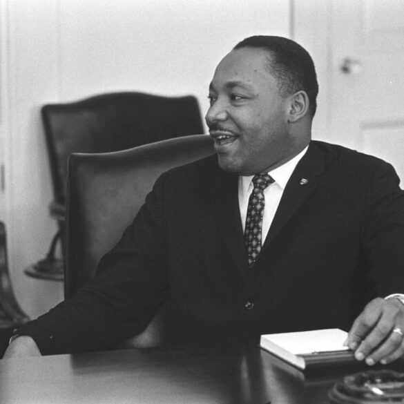 Martin Luther King, Jr. sitting at desk - Restorative Justice: The Next Step on Dr. King’s Path?