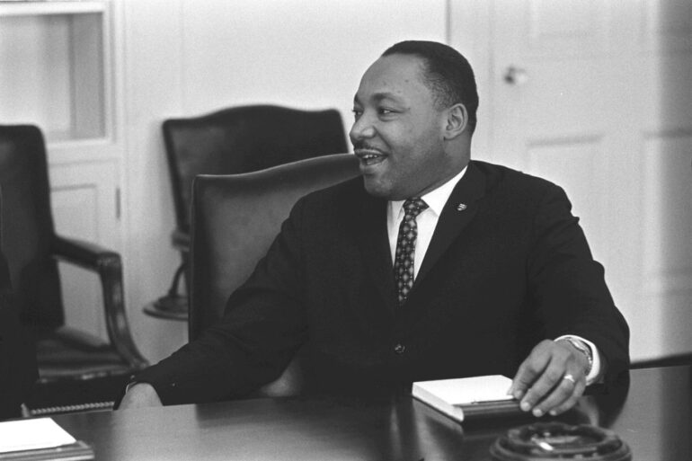 BEYOND THE DREAM: Continuing Dr. King's vision for global justice and compassion 17 Martin Luther King, Jr. sitting at desk - Restorative Justice: The Next Step on Dr. King’s Path?