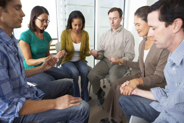Prayer group meeting on chairs - Mindful Technology: Preserving Spirituality in a World of AI