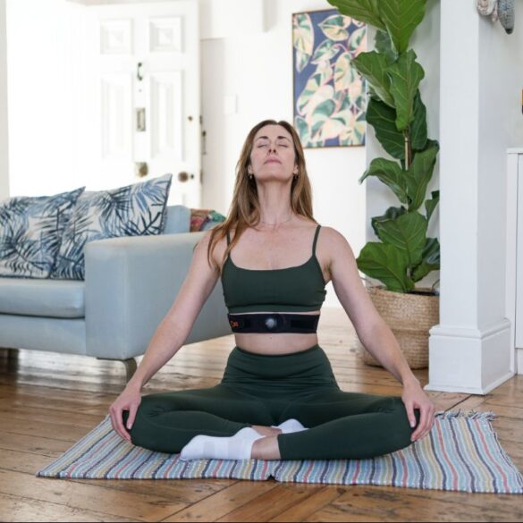 Woman doing breathwork at home on mat
