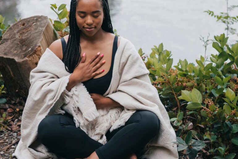 Woman doing breathwork exercise outdoors - Generational Healing: 4 Ways Simple Breathwork Can Help