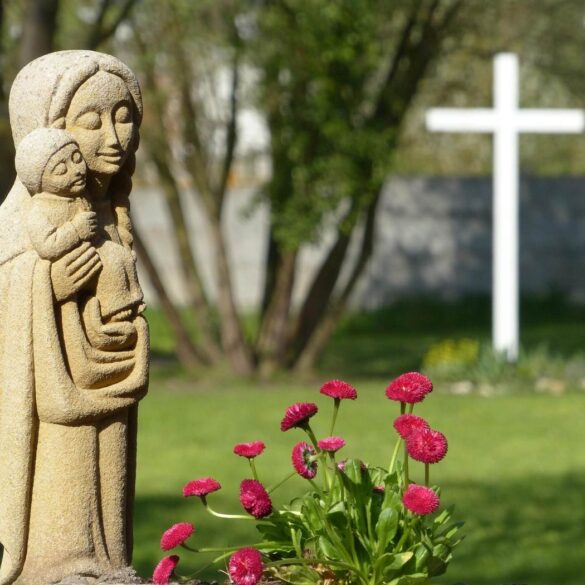Statue of Mary holding Baby Jesus next to cross - Reflections on Motherhood, Mindfulness Faith and Grace