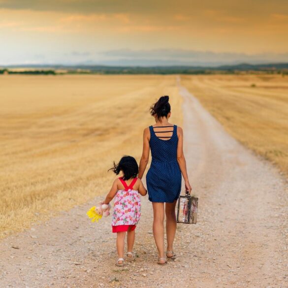 Mother and child walking along flat outdoor path, hand in hand - Self-Reclamation After Motherhood: Learn To Love The New You