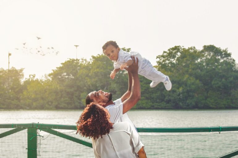Mother, father and child, with child being lifted by father - Conscious Parenting: 5 Great Ways to Improve Your Skills