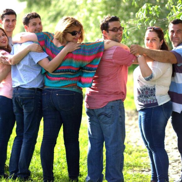 Group of Millennial friends with arms around each other at park - Millennials: 3 Big Questions They’re Asking Themselves