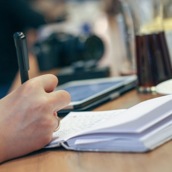 Person writing in notebook with coffee beside them - 4 Soft Steps to Help You Fully Embrace Forgiveness