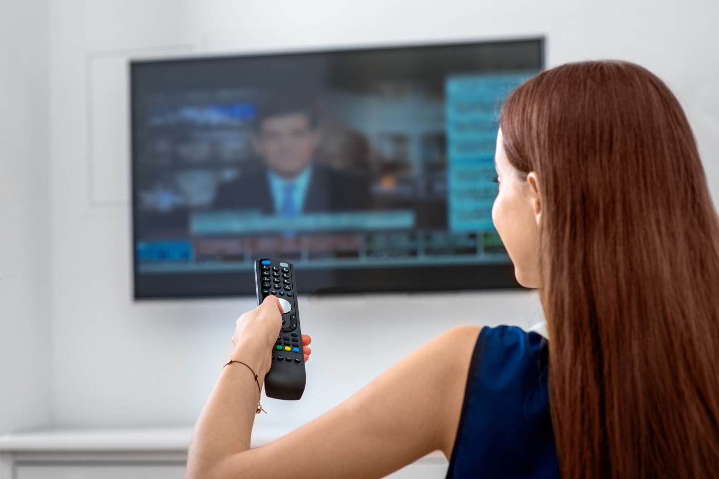 THE 24-HOUR NEWS CYCLE: How Stoicism can help people endure it in peace 13 Young woman watching news on TV - The 24-Hour News Cycle: How Stoicism Can Help Us Survive It