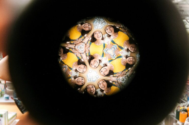 Multiple instances of woman's face showing through kaleidoscope lens - The Hypothetical Self: It’s Just a Powerful Illusion
