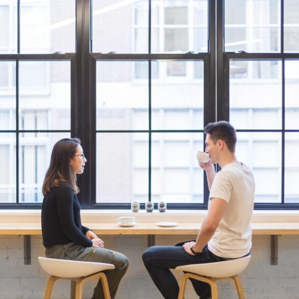 Young man and woman conversing over coffee - Mindful Listening: More Helpful Than Quickly Giving Advice
