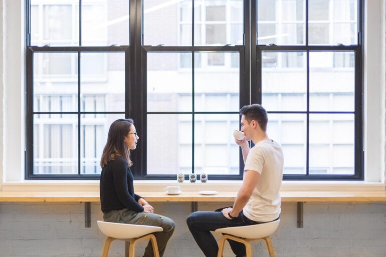 Young man and woman conversing over coffee - Mindful Listening: More Helpful Than Quickly Giving Advice