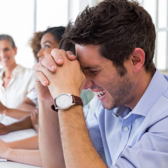 Four co-workers laughing at business meeting - 6 Actionable Tools That'll Help You Life a Happier Life