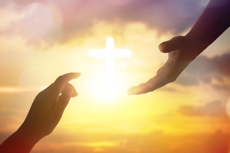 Hand of Jesus or God reaching out to a human to help them - How Faith Can Keep You Going Through Fear and Adversity