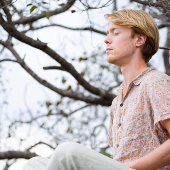 Man meditating in front of tree - The Heart of Awareness: Peacefully Moving Beyond the Mind