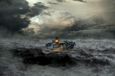 Boat with lantern floating in stormy water - The Path to Inner Simplicity Starts With Mindfulness